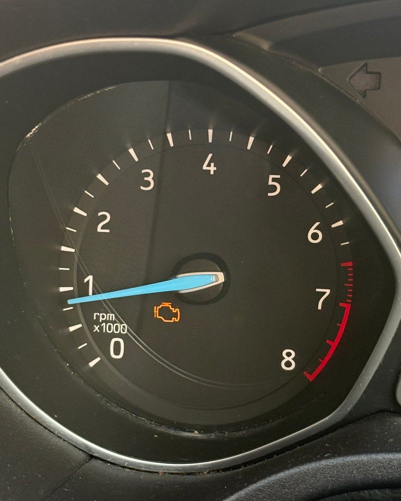 Rev counter with the orange engine warning light on