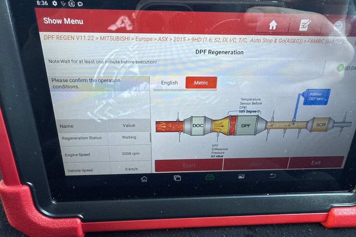 Launch diagnostic tablet plugged into a car, showing the DPF regeneration screen with live readings